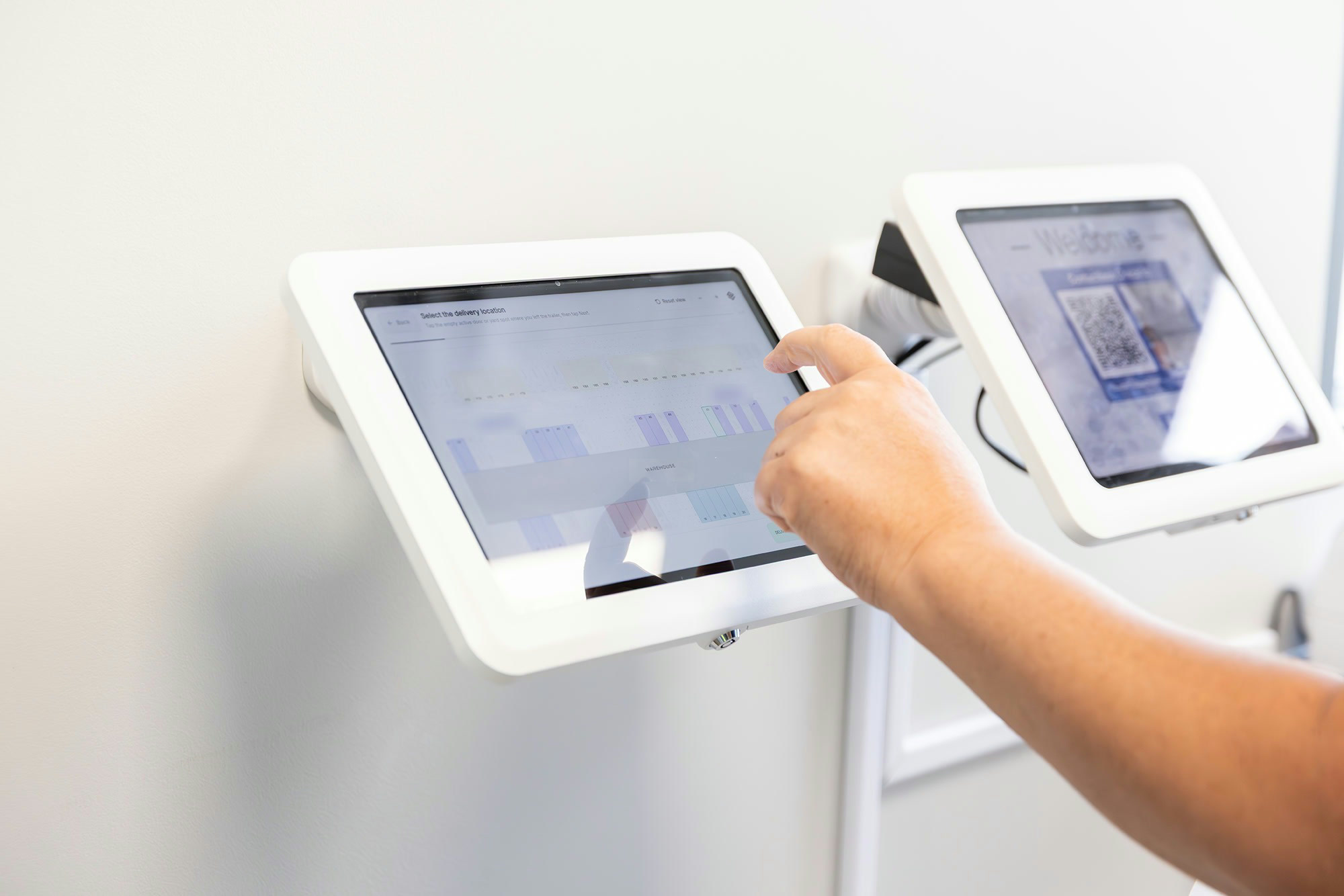 A driver checking in on the wall-mounted kiosk during an after-hours night drop